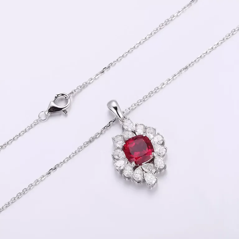 Cushion Cut Lab Ruby Pendant Featuring A Cluster Of Pear Cut Moissanite